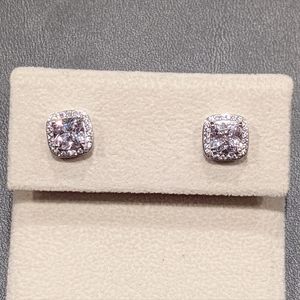 Cushion cut cubic zirconia with pave halo stud earrings. Rhodium plated silver.